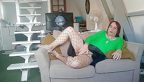 French redhead sits on the chair and plays with hair