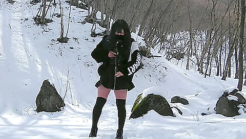 Asian brunette exposing herself in snow-covered mountains